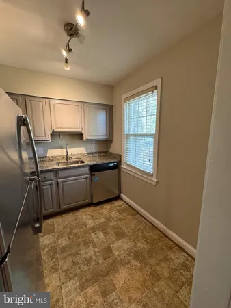 a kitchen with a stove a sink and a refrigerator