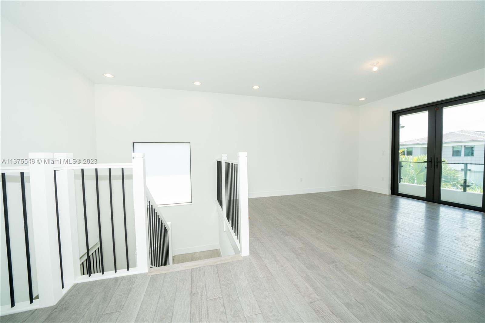 17232 Teton River Road Boca Raton, FL 33496 - Photo 11 of 28 wooden floor in an empty room with a window