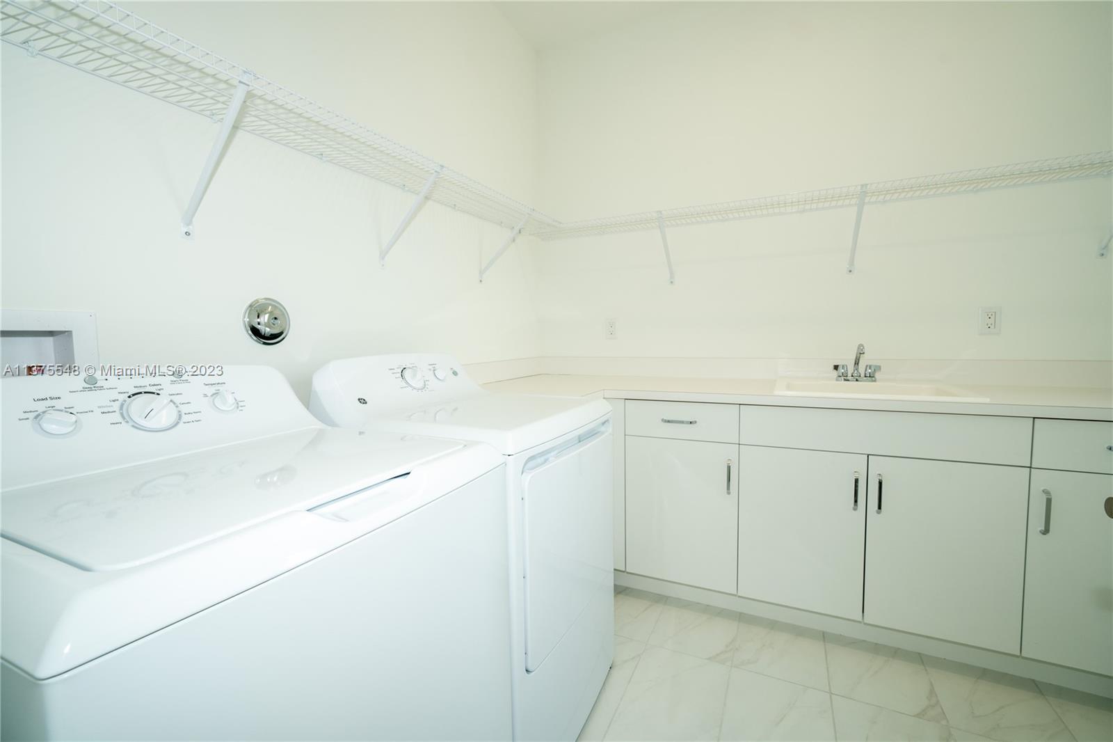 17232 Teton River Road Boca Raton, FL 33496 - Photo 12 of 28 a utility room with cabinets washer and dryer