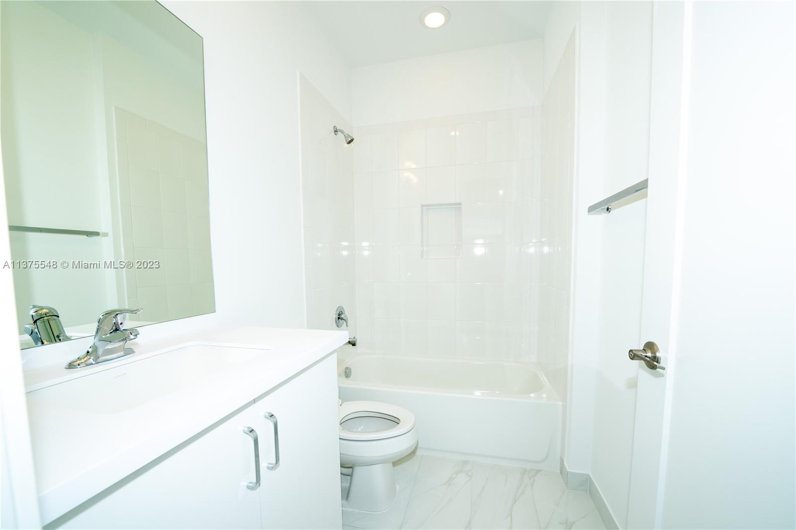 17232 Teton River Road Boca Raton, FL 33496 - Photo 13 of 28 a bathroom with a sink a toilet and shower