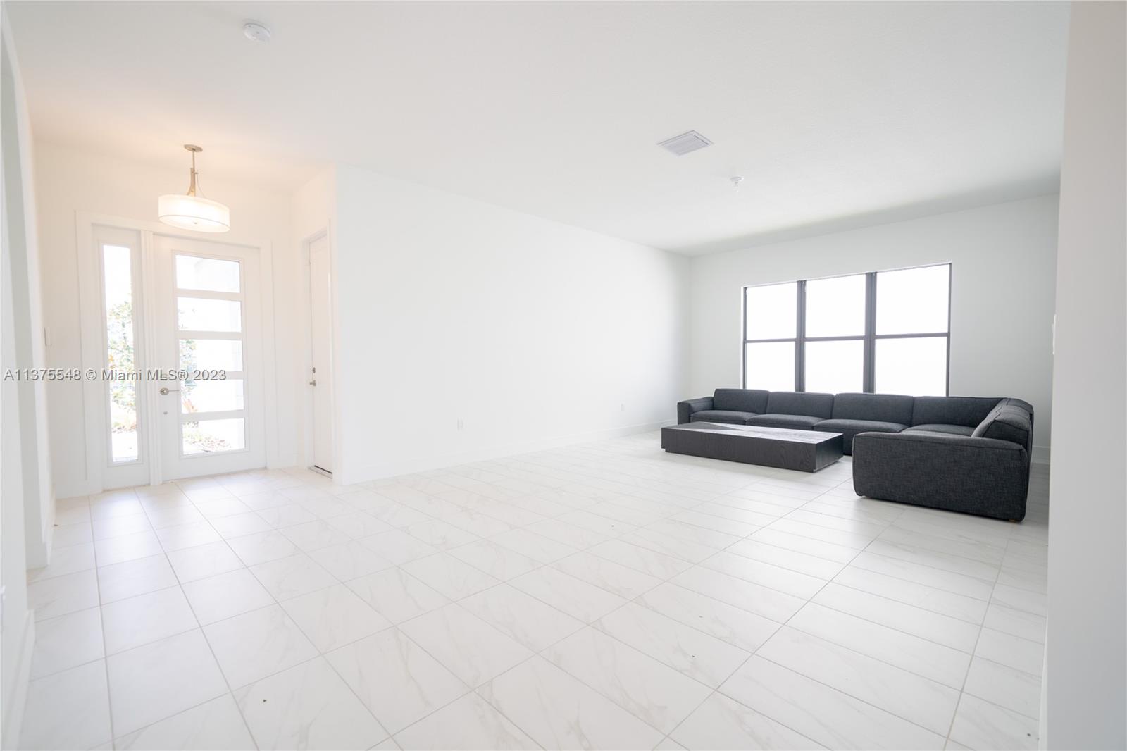 17232 Teton River Road Boca Raton, FL 33496 - Photo 4 of 28 a living room with furniture and a floor to ceiling window