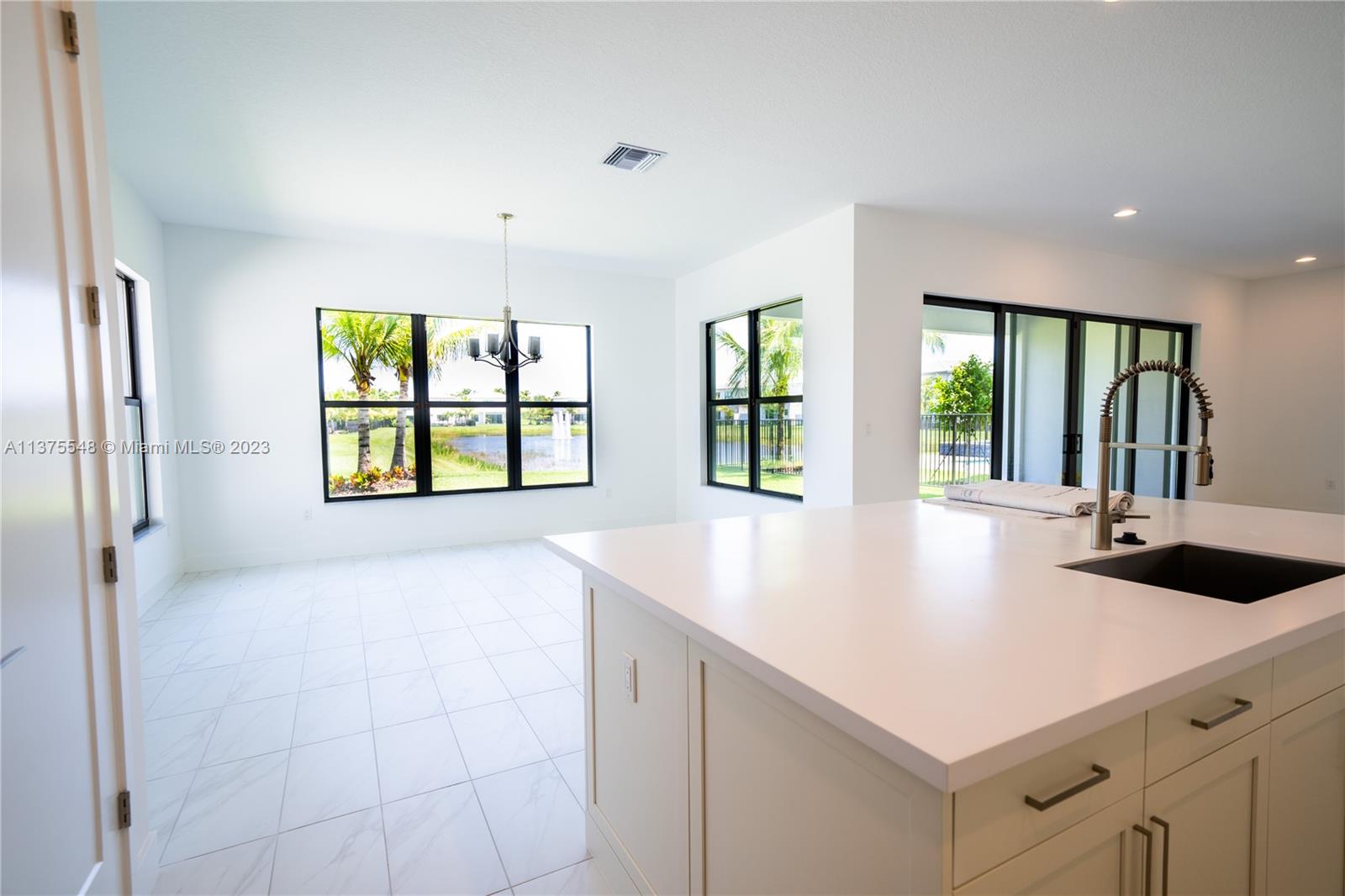 17232 Teton River Road Boca Raton, FL 33496 - Photo 7 of 28 a view of kitchen with windows and chandelier