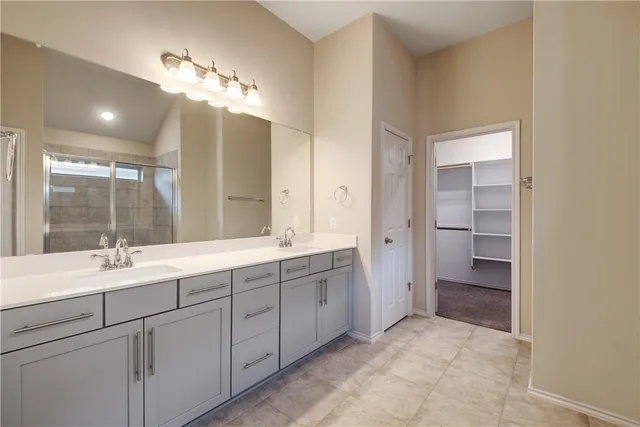 a bathroom with a double vanity sink and a mirror