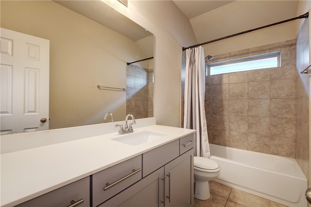 104 Finley Street Hutto, TX 78634 - Photo 20 of 37 a bathroom with a sink a toilet and shower