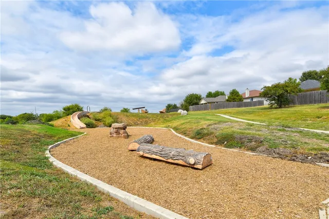 a view of a swimming pool and a yard