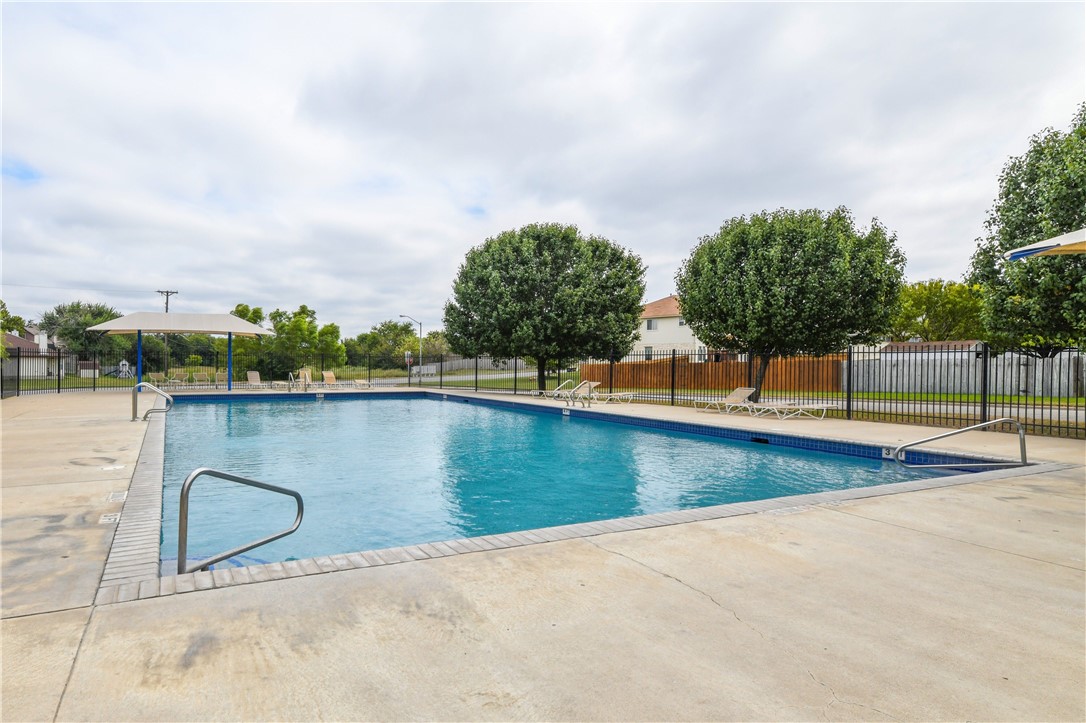 104 Finley Street Hutto, TX 78634 - Photo 36 of 37 a view of a swimming pool with an outdoor seating and a lake view