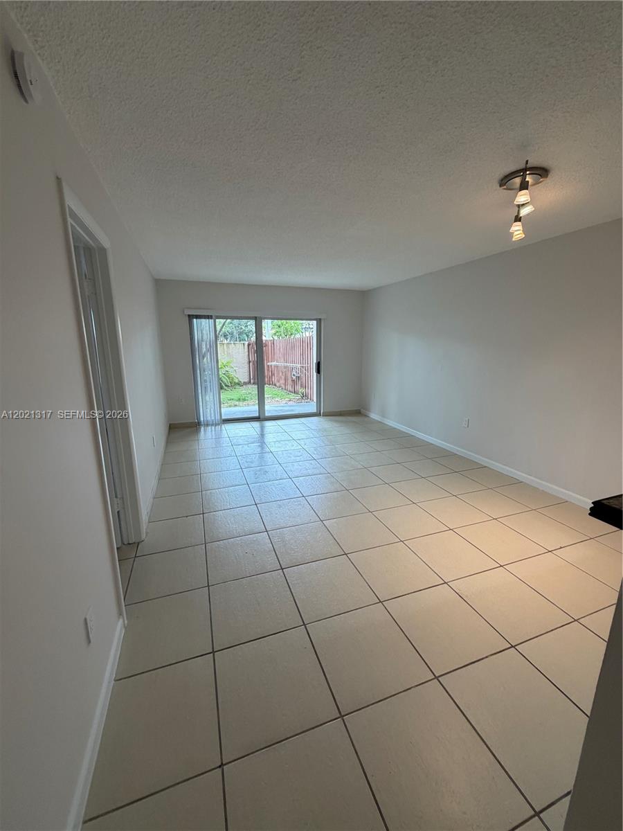 11201 Southwest 88th Street, Unit 102A Miami, FL 33173 - Photo 3 of 12 a view of an empty room and a window