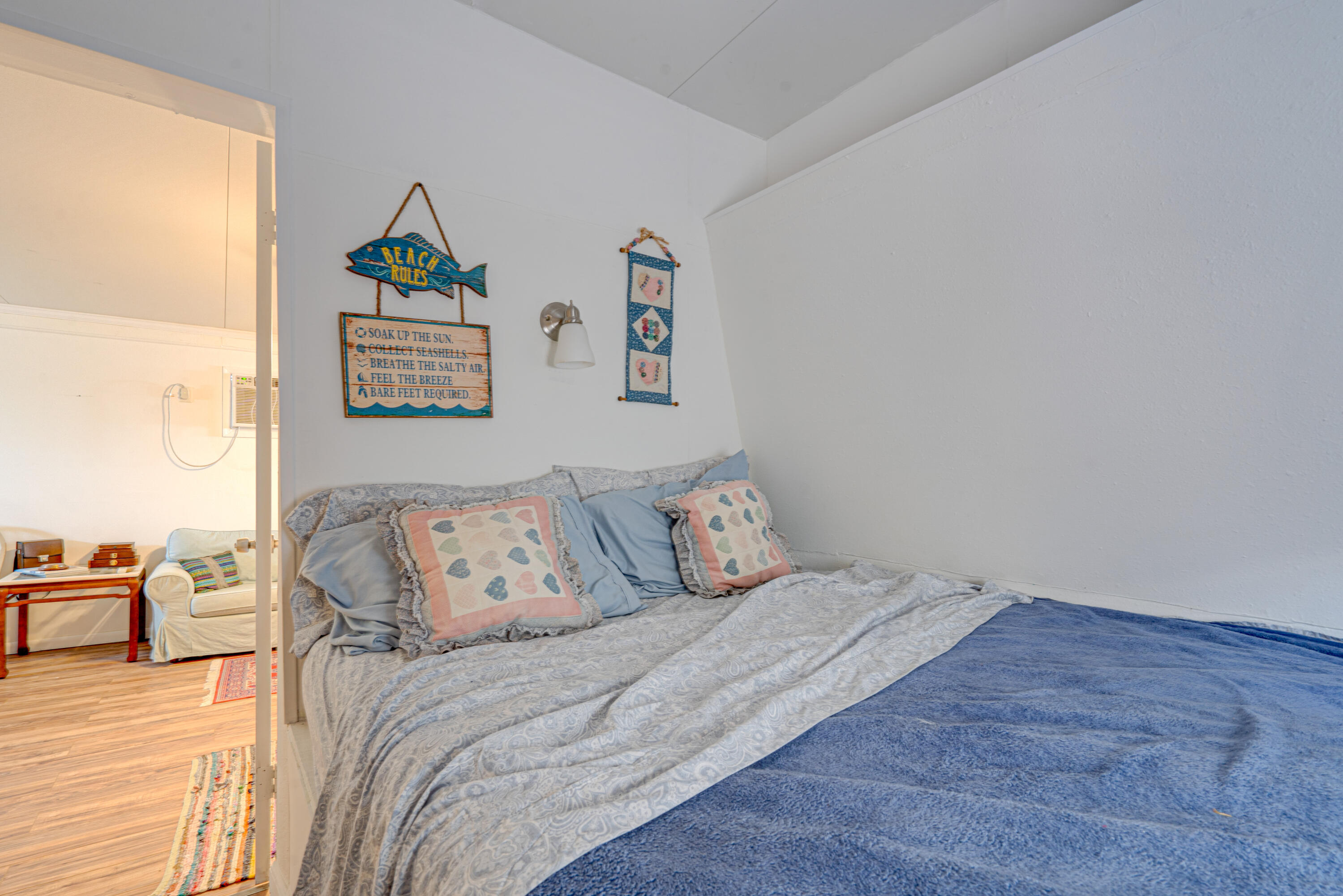 1361 Overseas Highway, Unit E11 Marathon, FL 33050 - Photo 31 of 46 a bedroom with a bed and wooden floor