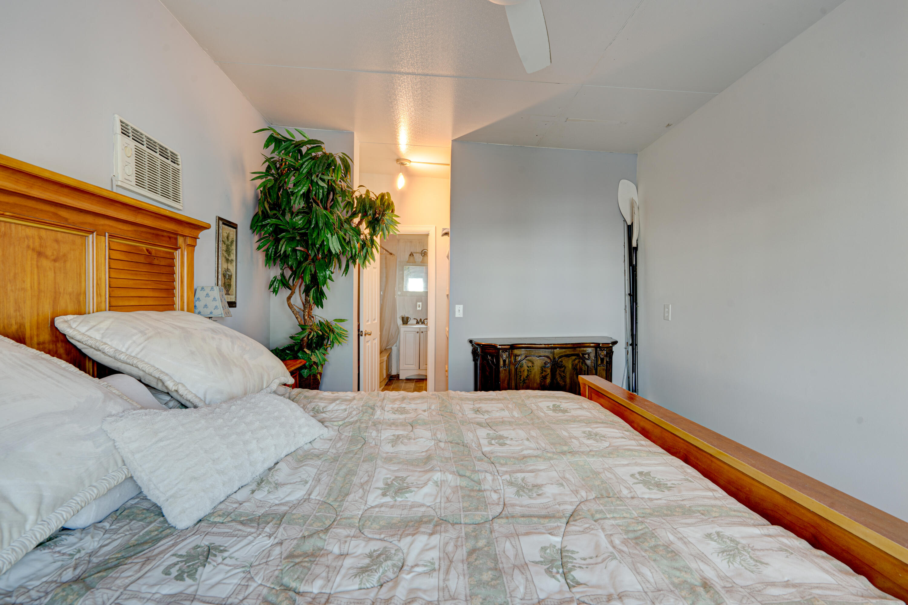 1361 Overseas Highway, Unit E11 Marathon, FL 33050 - Photo 37 of 46 a bedroom with a large bed and a potted plant