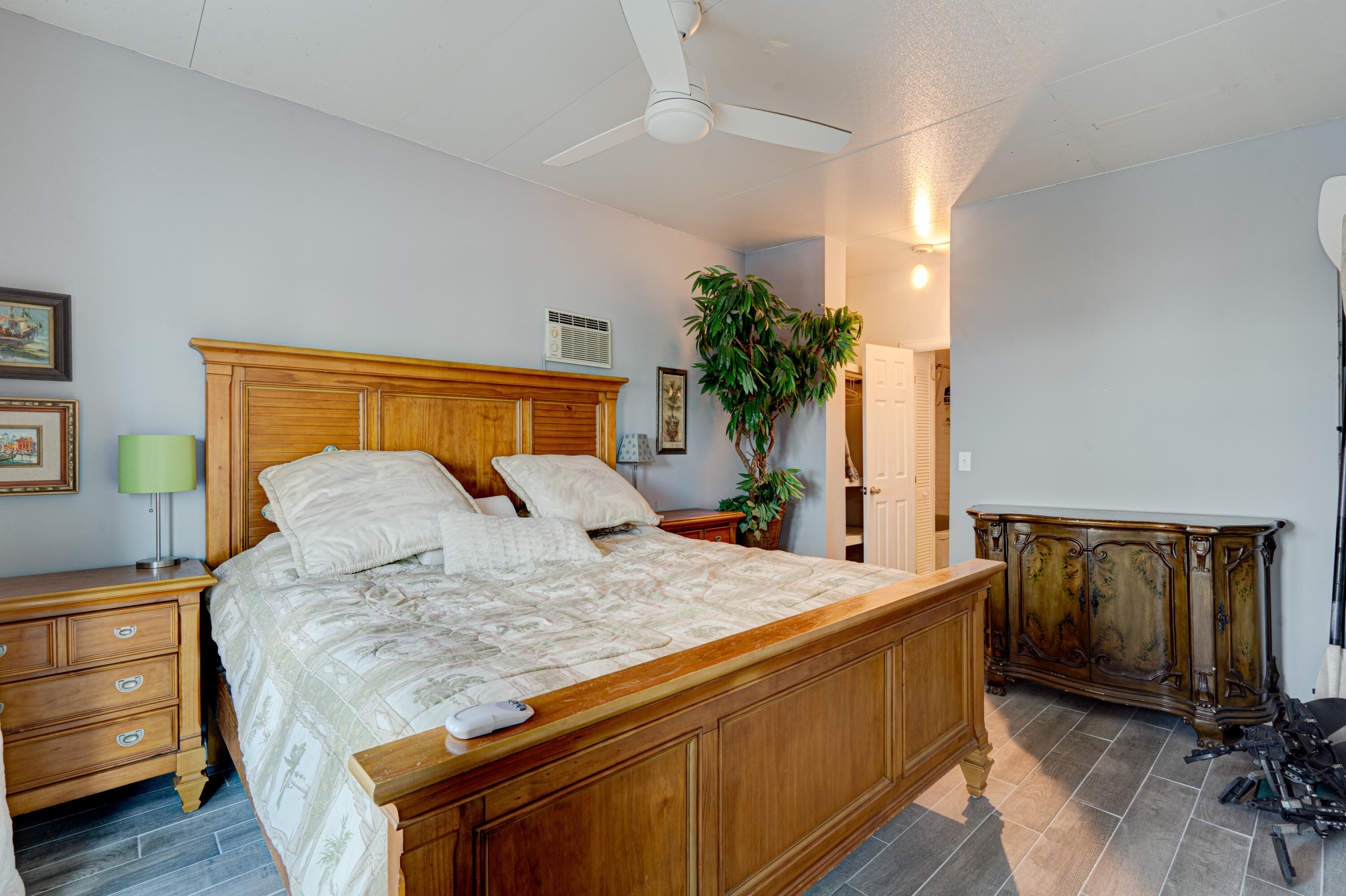 1361 Overseas Highway, Unit E11 Marathon, FL 33050 - Photo 38 of 46 a bedroom with a bed and a potted plant on the dresser