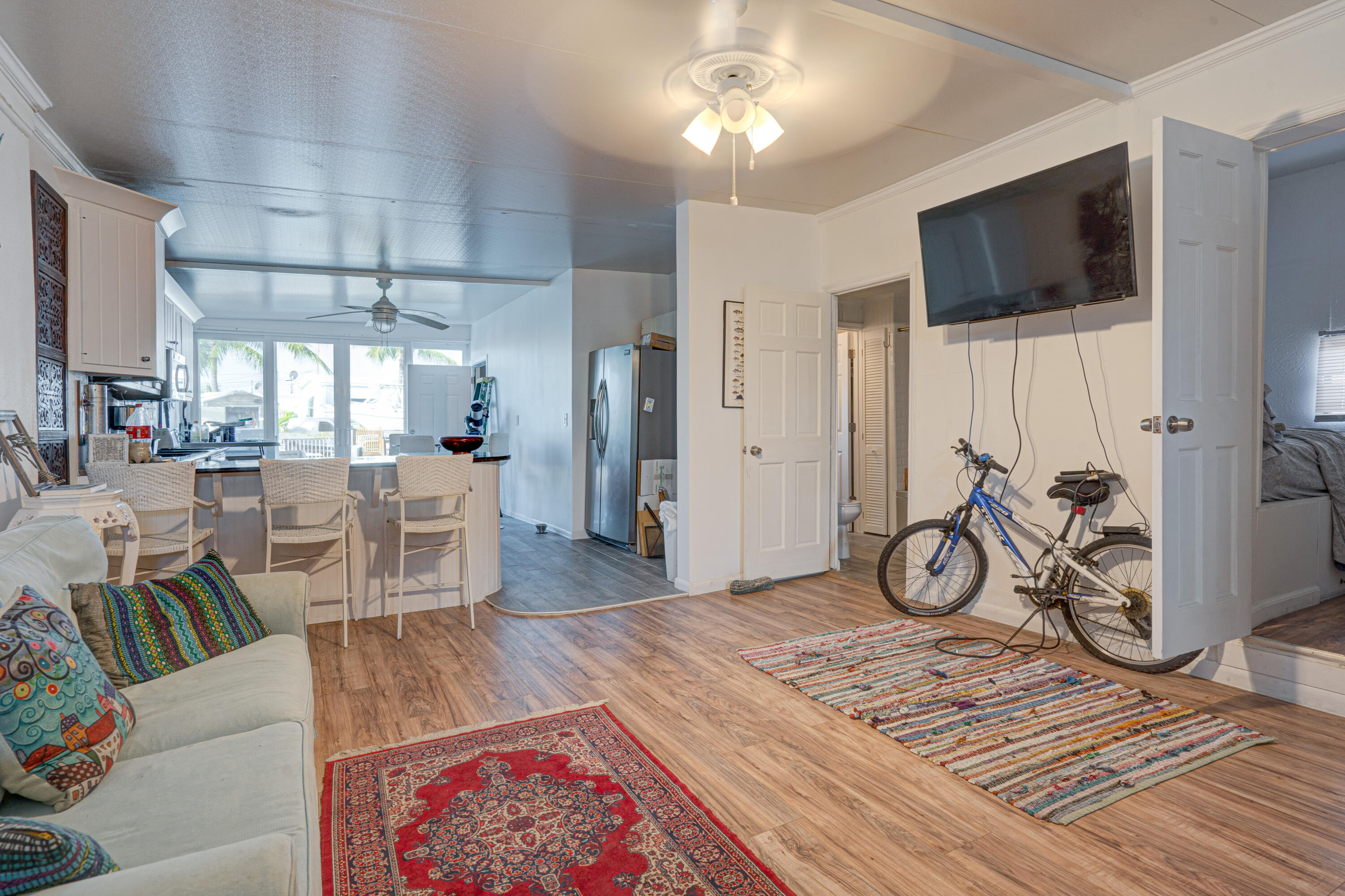 1361 Overseas Highway, Unit E11 Marathon, FL 33050 - Photo 4 of 46 a living room with furniture a flat screen tv and a table