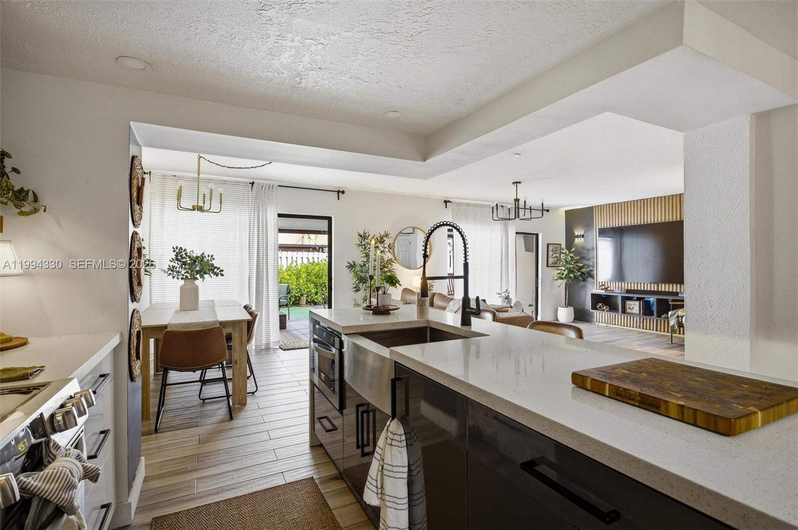 14019 Southwest 67th Terrace Miami, FL 33183 - Photo 15 of 36 a kitchen with sink a counter and chairs