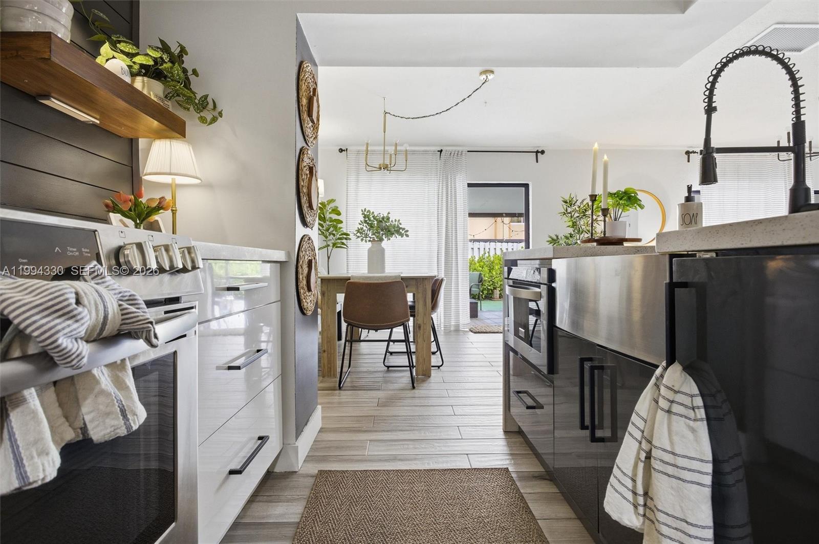14019 Southwest 67th Terrace Miami, FL 33183 - Photo 17 of 36 a living room with furniture a dining table and paintings on the wall