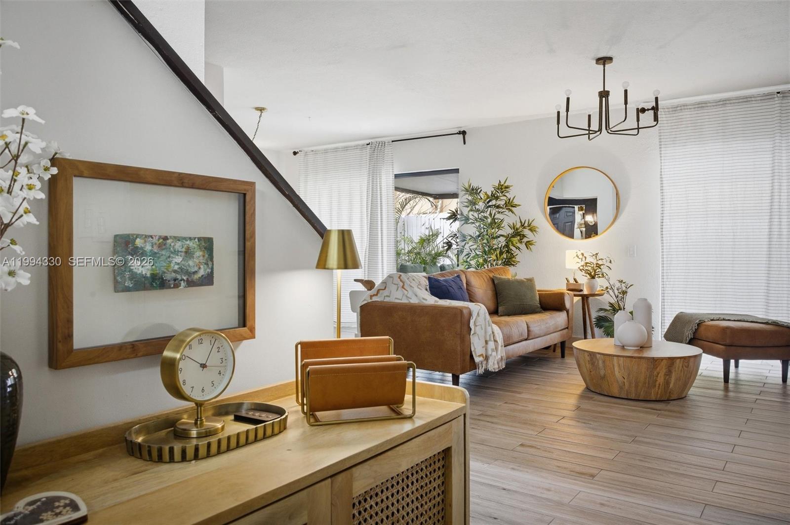 14019 Southwest 67th Terrace Miami, FL 33183 - Photo 19 of 36 a living room with furniture a rug and a chandelier