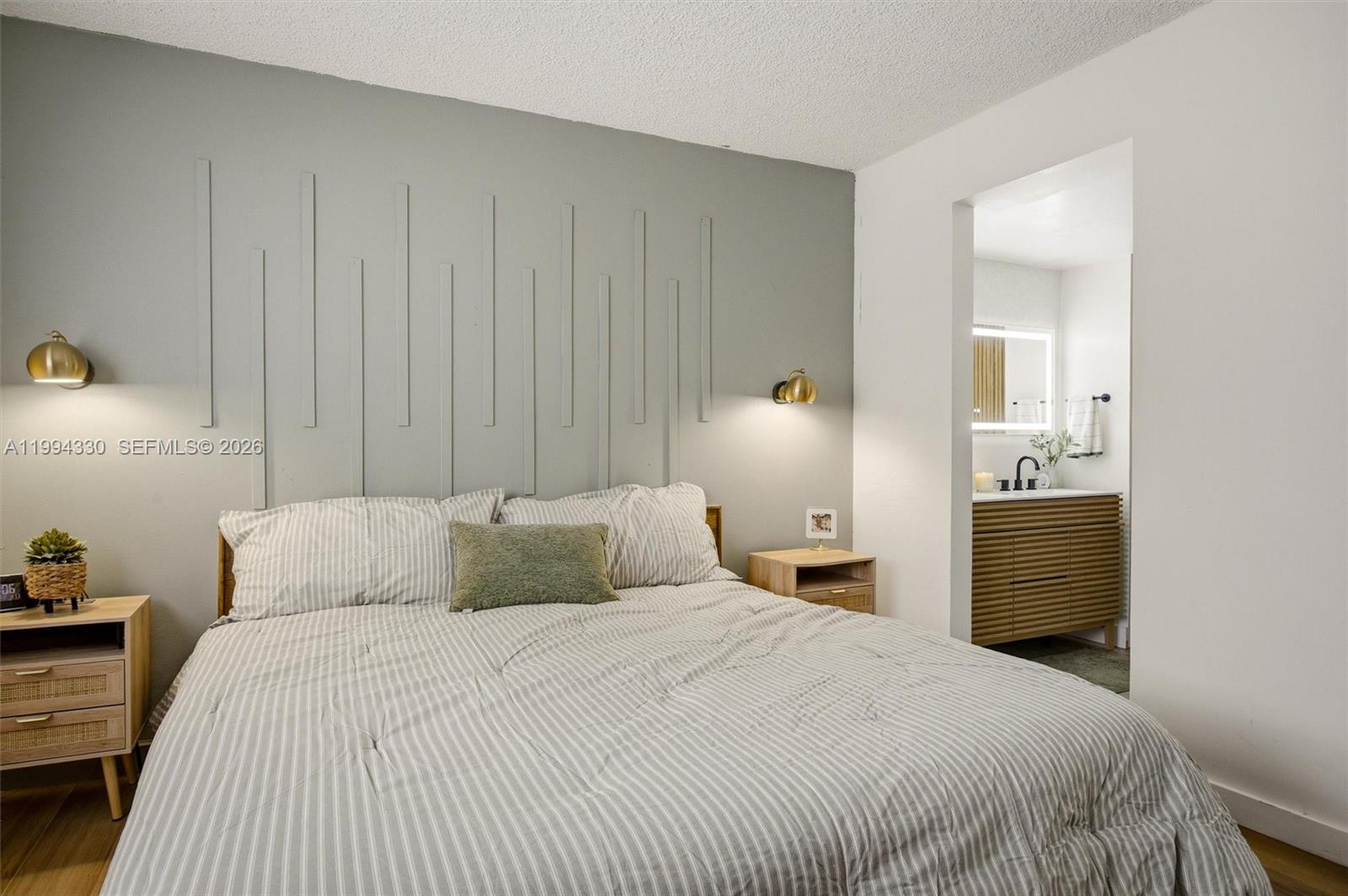 14019 Southwest 67th Terrace Miami, FL 33183 - Photo 21 of 36 a bedroom with a large bed and wooden floor