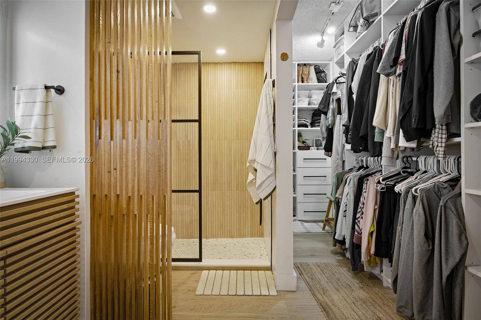 14019 Southwest 67th Terrace Miami, FL 33183 - Photo 25 of 36 a view of walk in closet with clothes and shoes