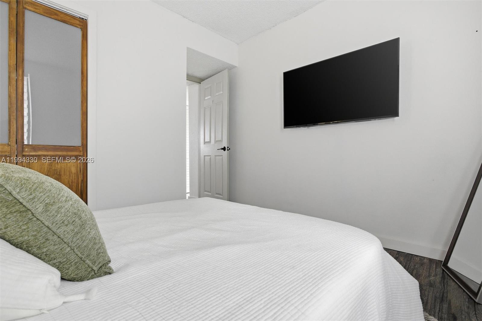 14019 Southwest 67th Terrace Miami, FL 33183 - Photo 29 of 36 a bedroom with a flat screen tv and a bed