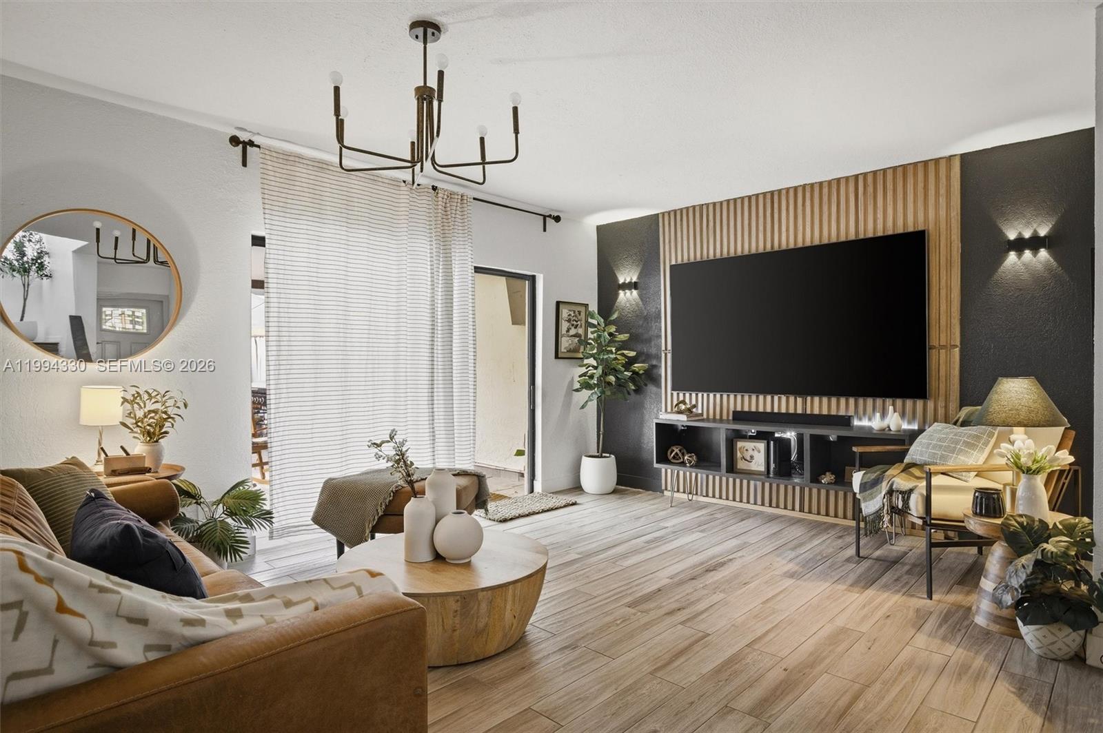 14019 Southwest 67th Terrace Miami, FL 33183 - Photo 3 of 36 a living room with furniture and a flat screen tv