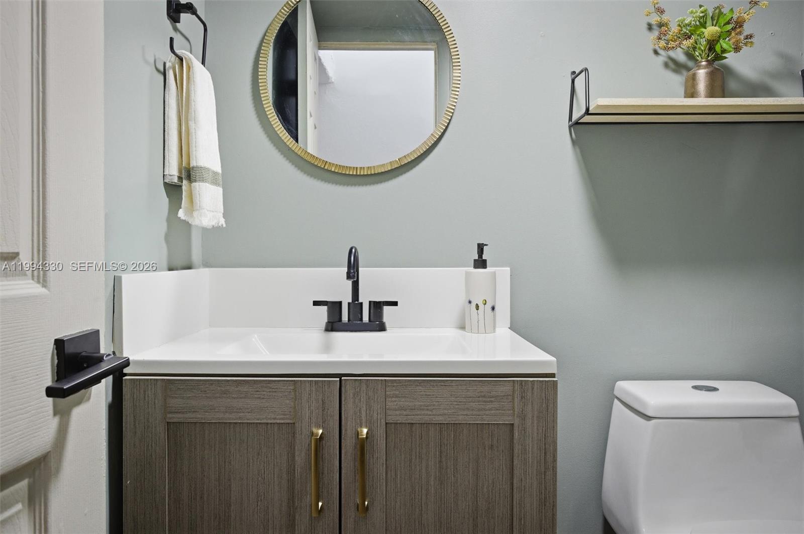 14019 Southwest 67th Terrace Miami, FL 33183 - Photo 32 of 36 a bathroom with a sink and a mirror