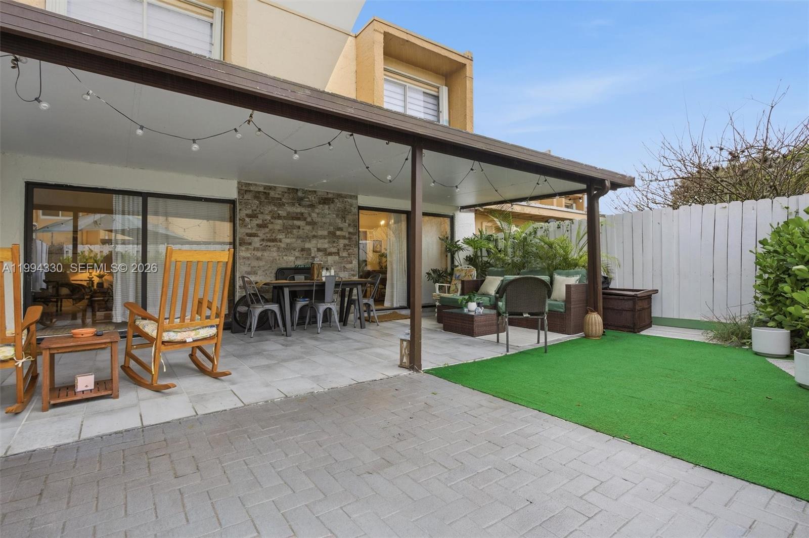 14019 Southwest 67th Terrace Miami, FL 33183 - Photo 33 of 36 a view of a patio with table and chairs potted plants and floor to ceiling window