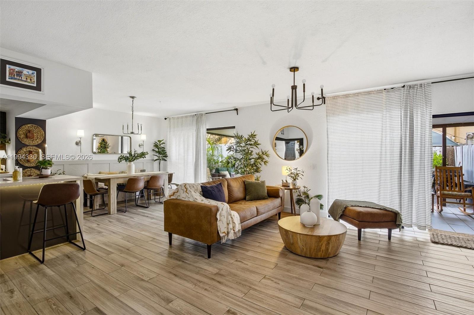 14019 Southwest 67th Terrace Miami, FL 33183 - Photo 5 of 36 a living room with furniture a chandelier and wooden floor