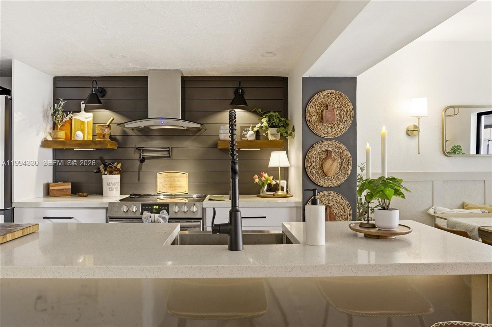 14019 Southwest 67th Terrace Miami, FL 33183 - Photo 10 of 36 a kitchen with a sink and a stove top oven