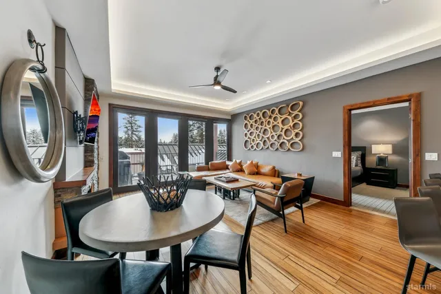 a dining room with furniture a chandelier and wooden floor