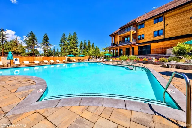 a backyard of a house with lots of green space and fountain
