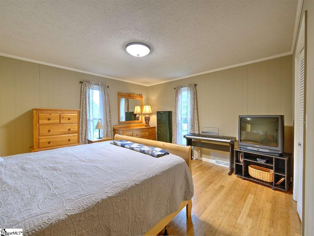 55 Arnold Branch Road Woodruff, SC 29388 - Photo 20 of 36 Tucked in back corner of home is this secondary bedroom retreat complete with private bath and great storage space.