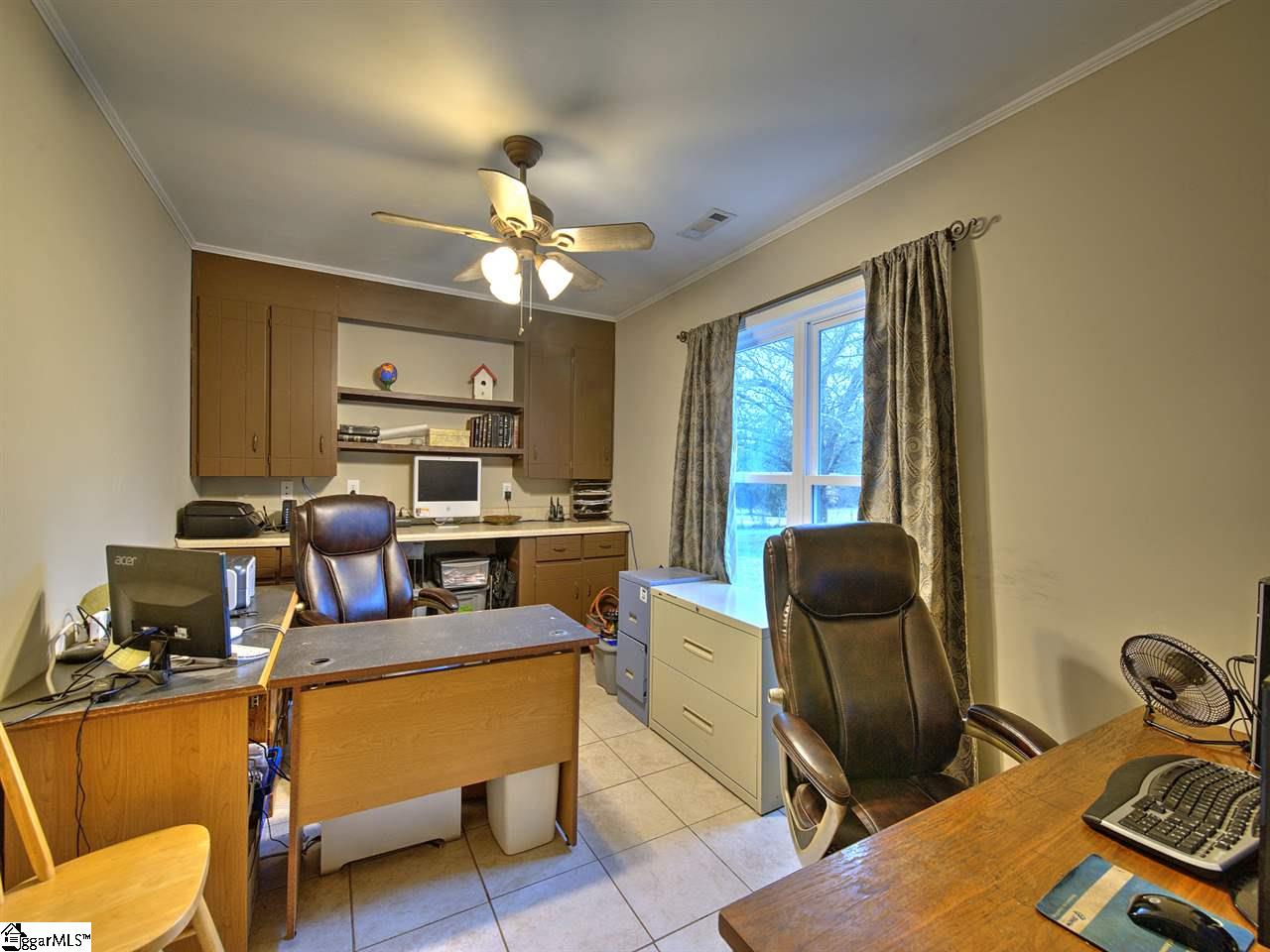55 Arnold Branch Road Woodruff, SC 29388 - Photo 23 of 36 Built-in cabinets and large window overlooking backyard