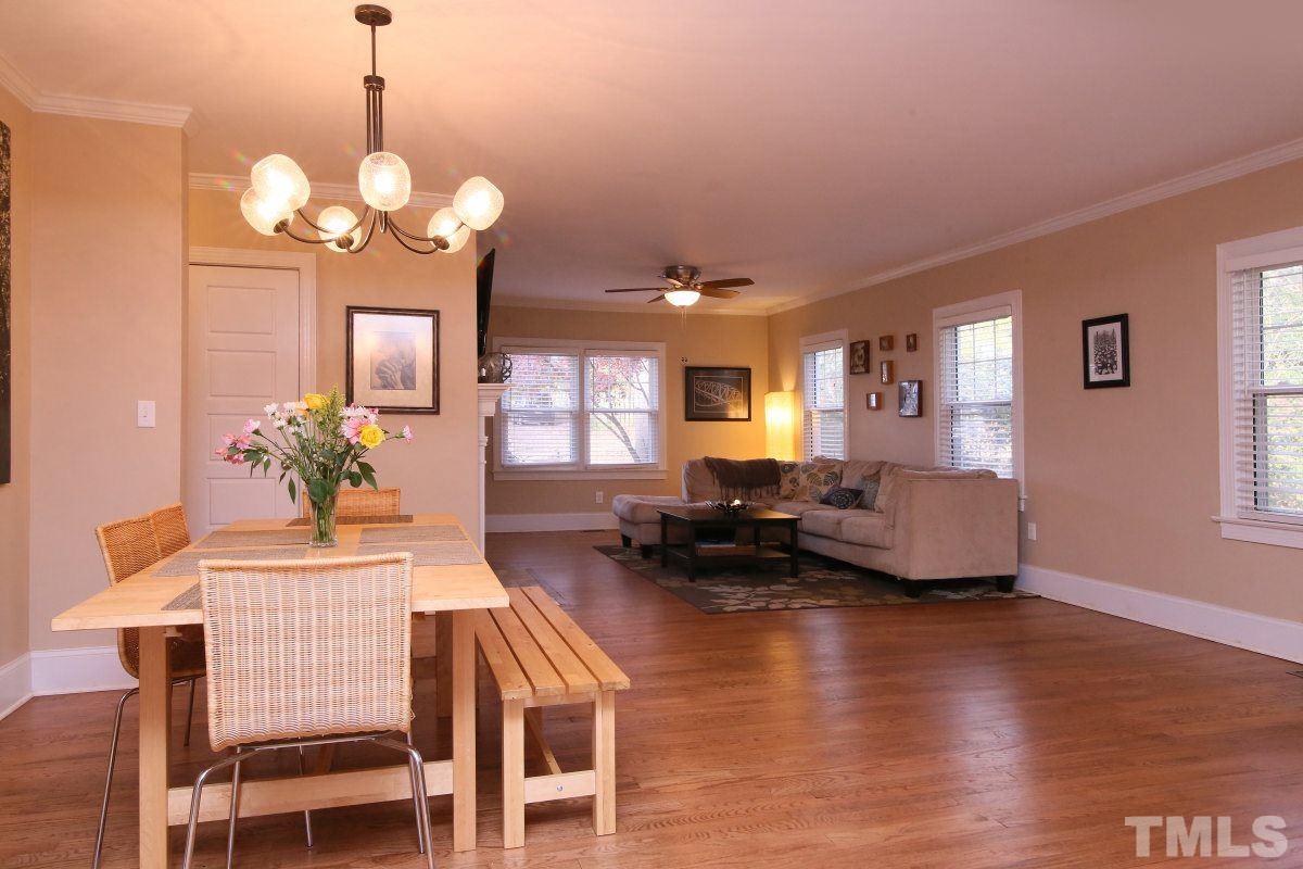 3007 Mayview Road Raleigh, NC 27607 - Photo 8 of 25 a view of a dining room with furniture a chandelier and wooden floor