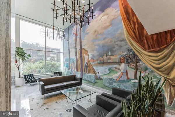 a living room with patio furniture and a floor to ceiling window