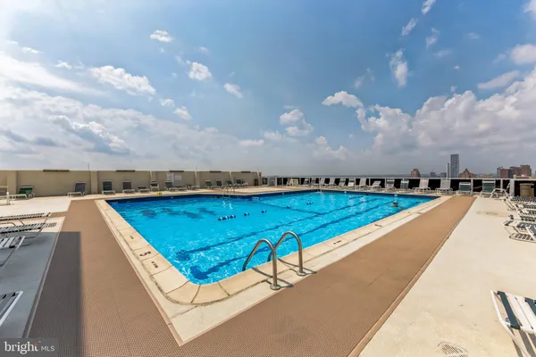a view of swimming pool with a yard and sitting area