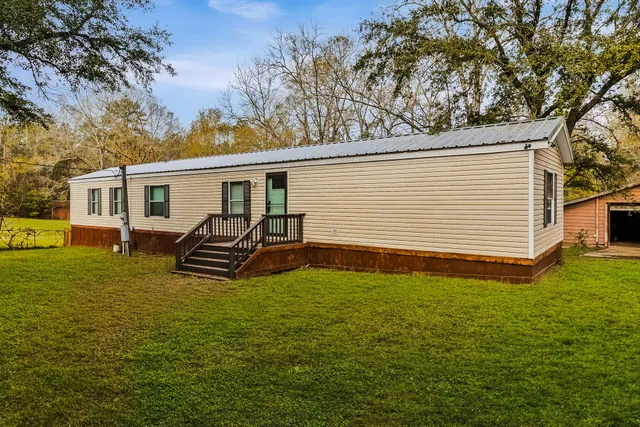 an empty room with kitchen appliances and wooden floor