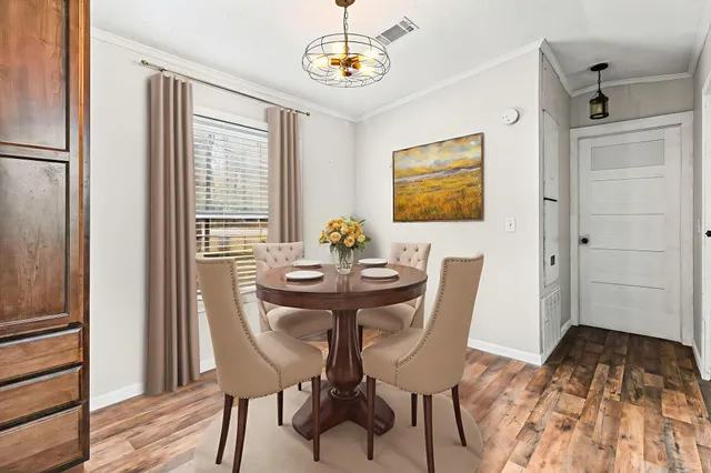 a view of a dining room with furniture window and wooden floor