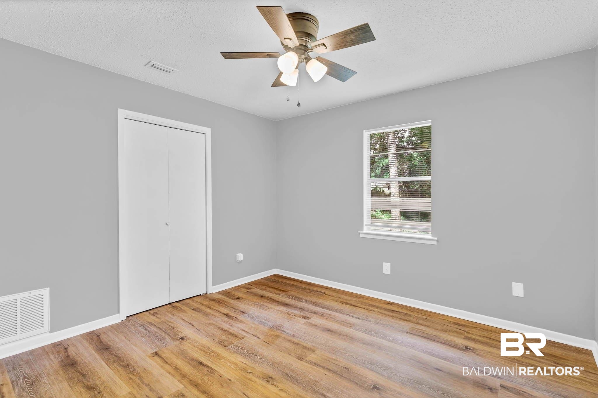 3304 Armond Drive Mobile, AL 36605 - Photo 35 of 62 Unfurnished bedroom featuring a closet, wood finished floors, a ceiling fan, and a textured ceiling