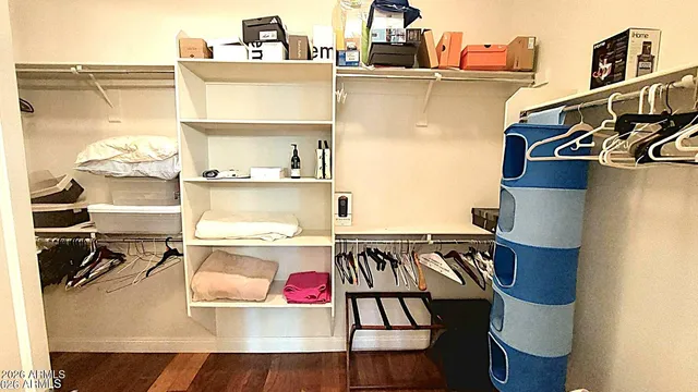 a bedroom with a bed wooden floor and window