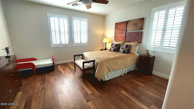 a view of staircase with lots of frames on wall and a window