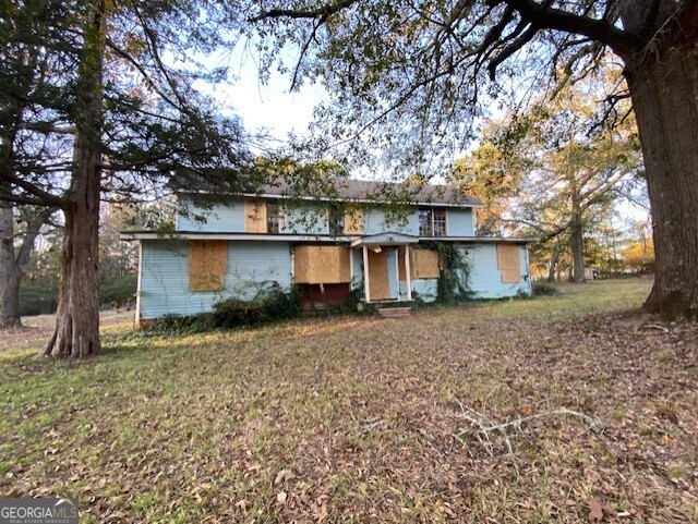 3011 Clack Road Madison, GA 30650 - Photo 24 of 27 a view of a house with a yard tree and a tree