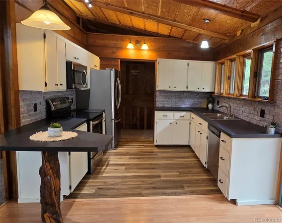 a kitchen with granite countertop a sink and cabinets