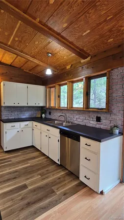 a kitchen with stainless steel appliances a stove microwave and refrigerator