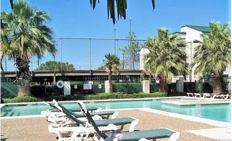 a view of a house with swimming pool and sitting area