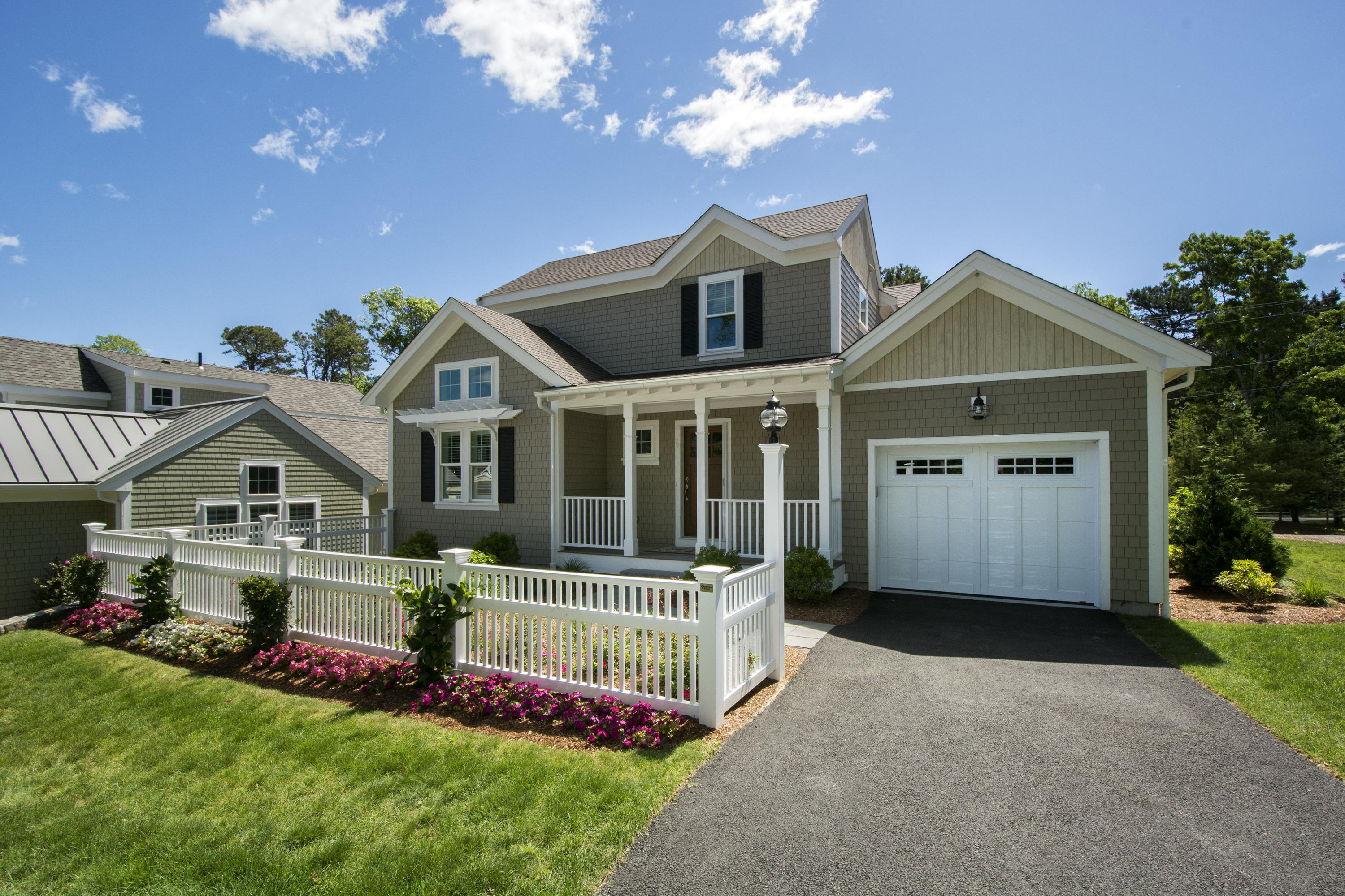 2 Cobblestone Circle Mashpee, MA 02649 - Photo 4 of 34 a front view of a house with a yard and garage