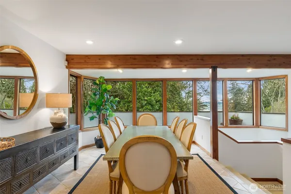 a dining room with furniture and a mirror