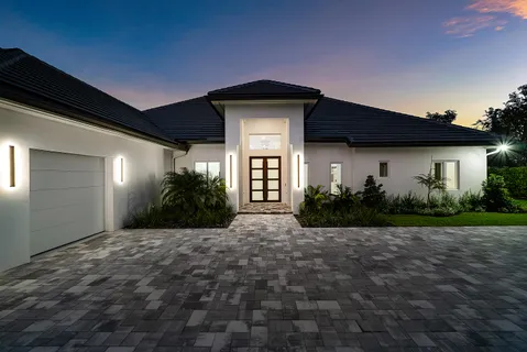 a front view of a house with garden