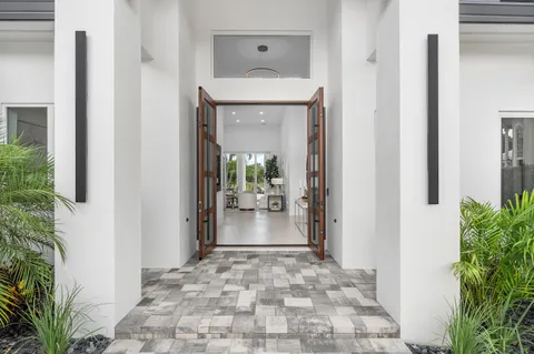 a living room with furniture and potted plant