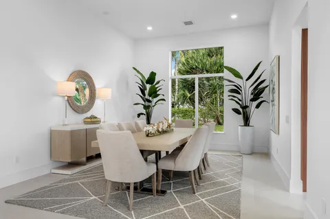 a living room with furniture a flat screen tv and a large window
