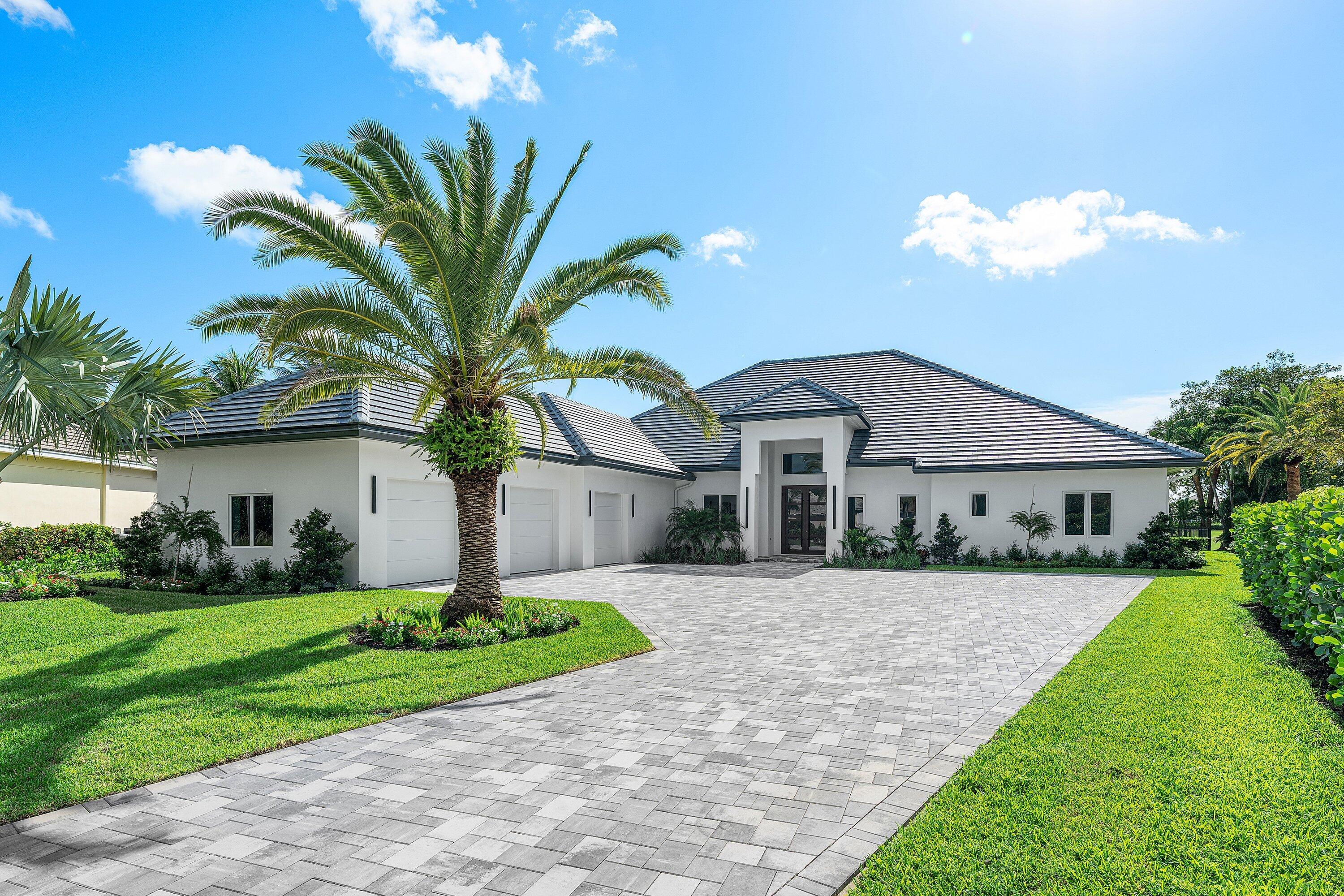 100 Glenbrook Court Atlantis, FL 33462 - Photo 4 of 97 a front view of house with yard and green space