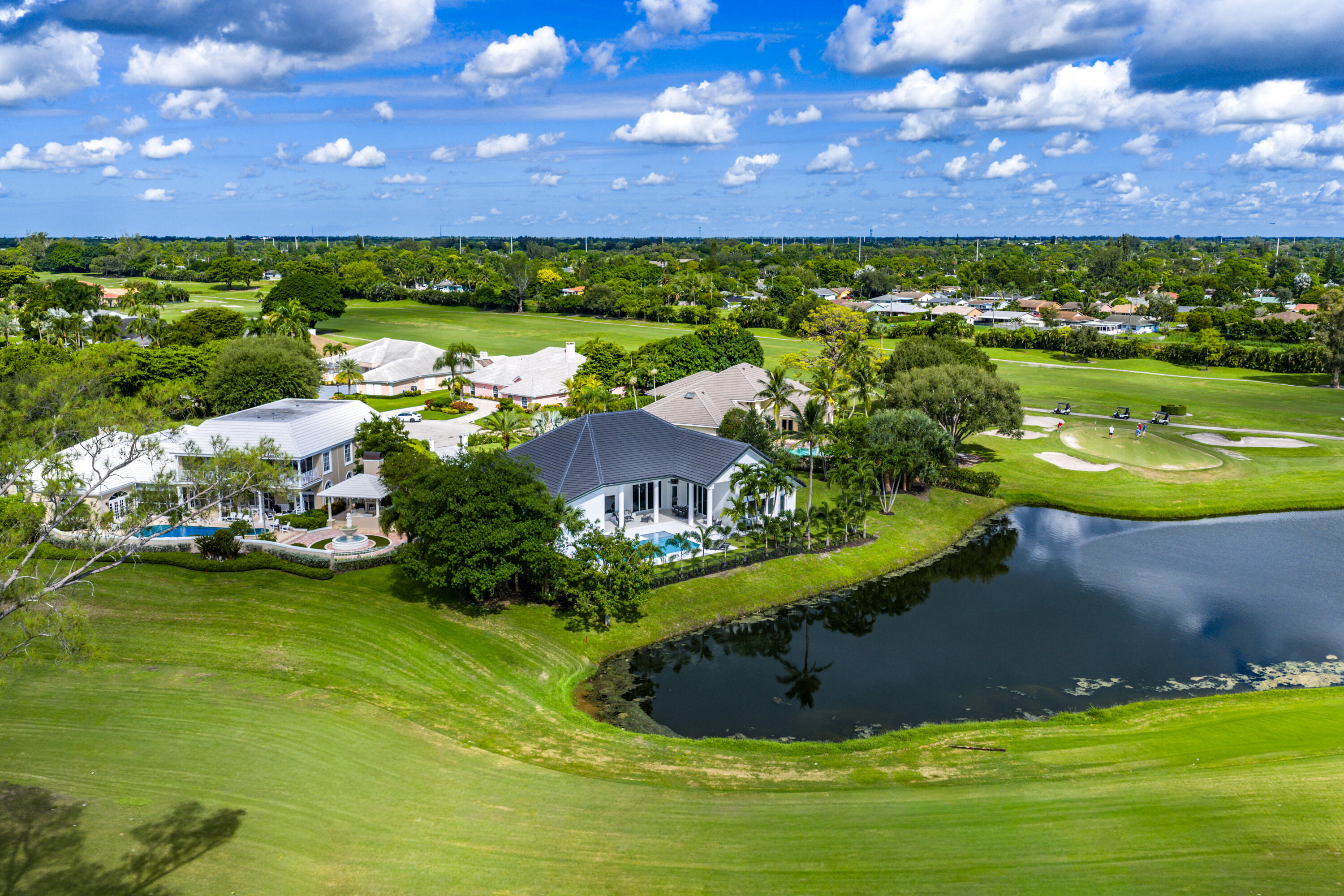 100 Glenbrook Court Atlantis, FL 33462 - Photo 85 of 97 a view of a golf course with a swimming pool