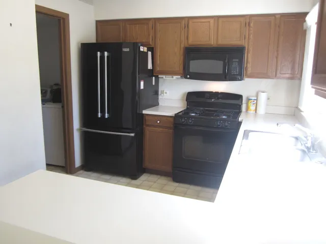 a kitchen with a refrigerator and a microwave